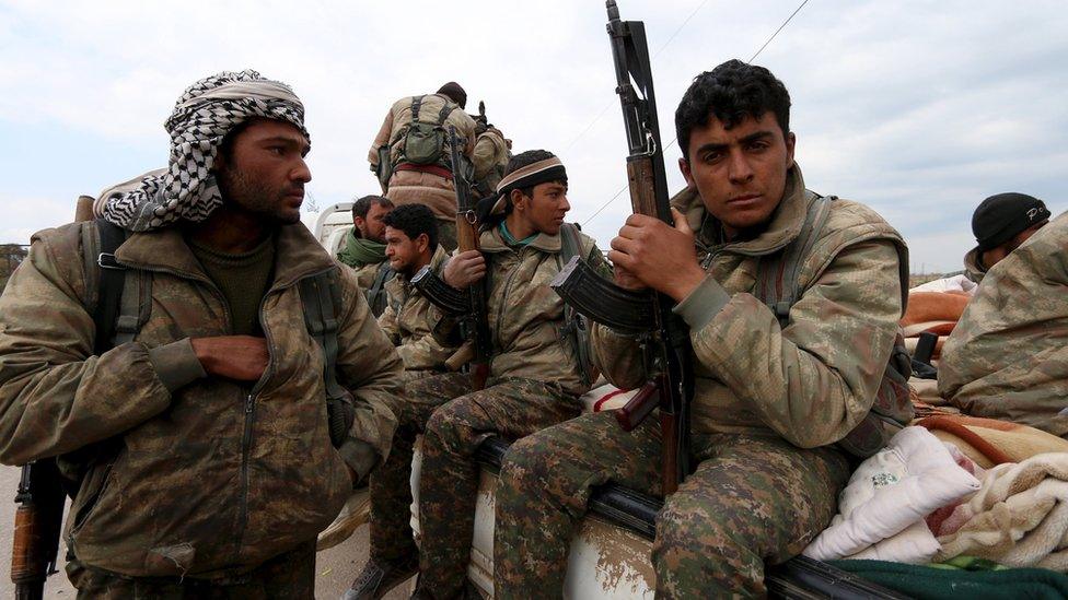 YPG fighters carry their weapons on a pick-up truck in Qamishli, Syria (11 March 2016)