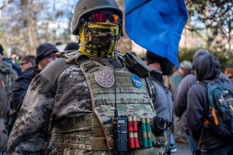 A gun rights activist defies Virginia's no masking law at the Lobby Day rally