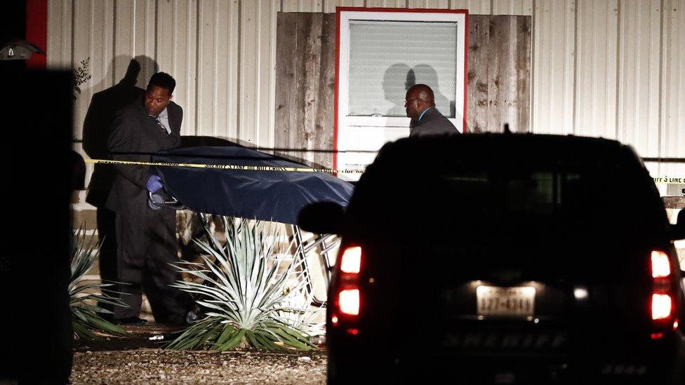 Officials are seen removing a covered stretcher from the party venue