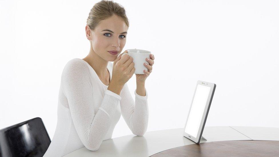 Woman with light box on a table