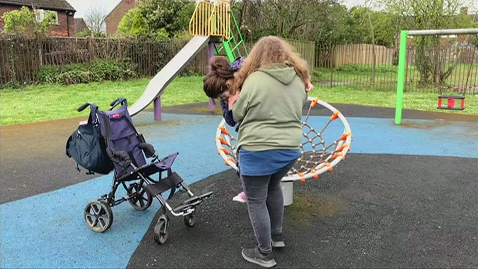 Lorna Fillingham helping her daughter at a play park