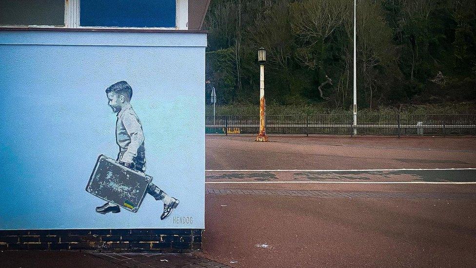 The mural showing the boy "skipping the border"