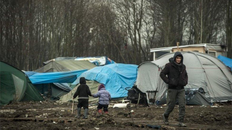 Children walk through the migrants camp of Grande-Synthe, near Dunkirk