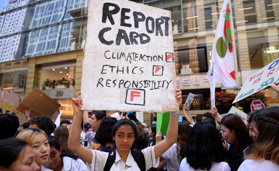 Kayna Fichadia (C) of North Sydney Girls" High School holds a placard as thousands of students rally demanding action on climate change from Australian Prime Minister Scott Morrison, in Sydney, Australia, 30 November 2018.