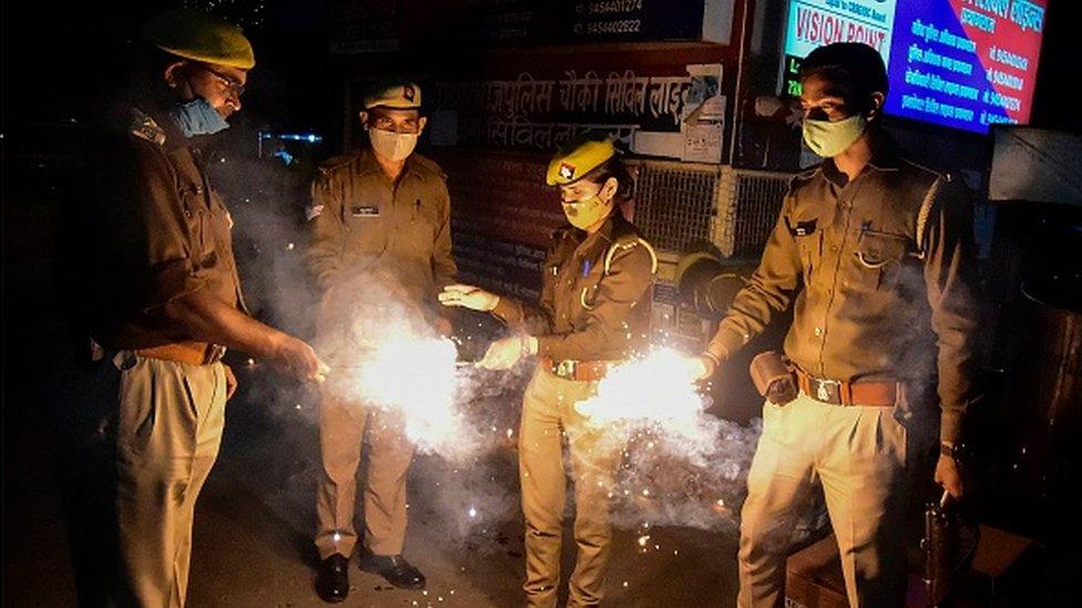 Police officers light sparklers during Diwali, the Hindu Festival of Lights, in Allahabad