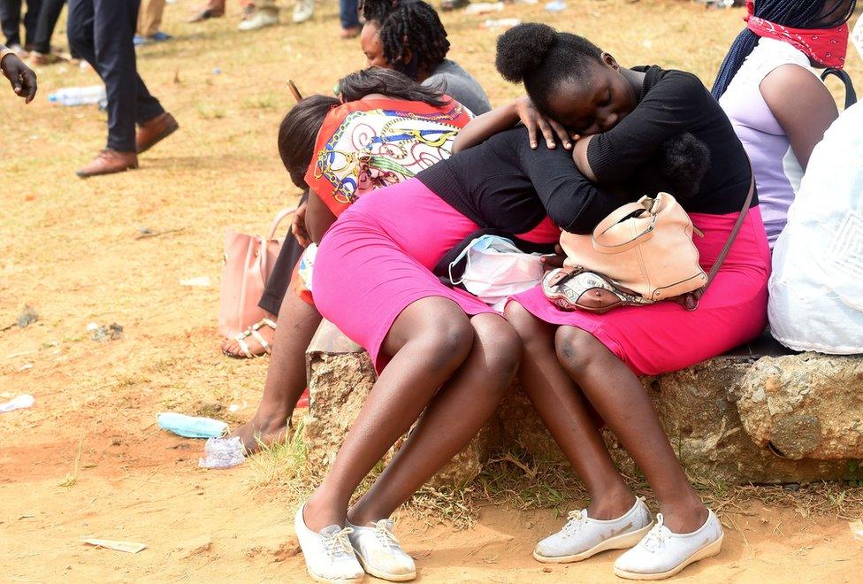 Women, with two of them in pink skirts and black tops