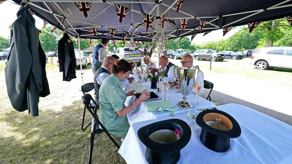 Picnic under a gazebo with jackets hanging up