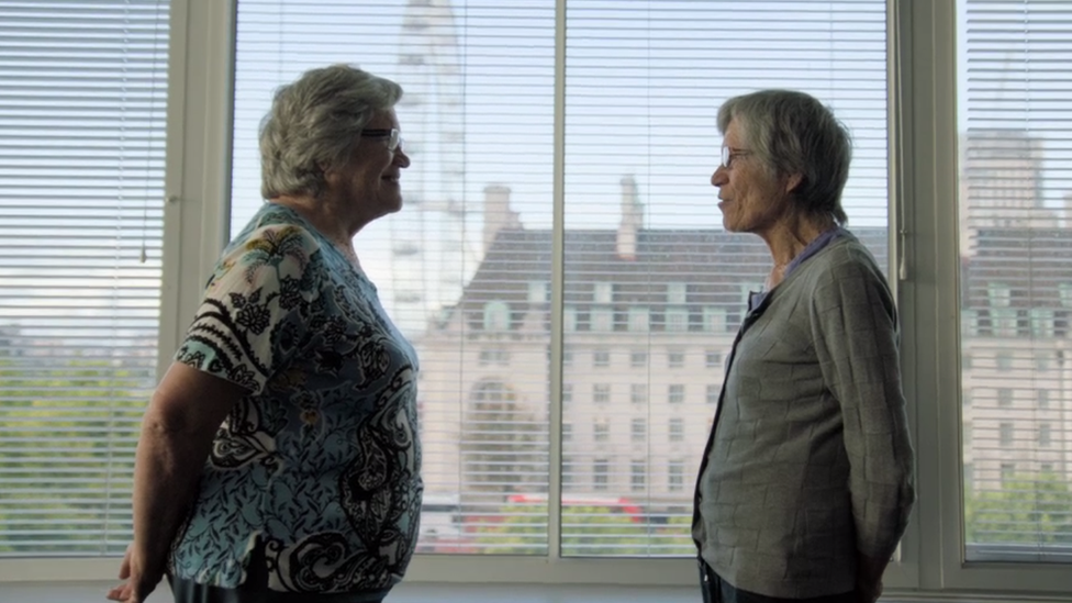 Twins Jackie and Gillian stand face to face