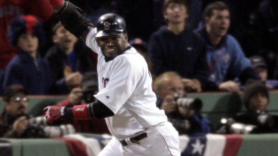 Boston Red Sox's David Ortiz celebrates his 14th inning game-winning single that scored teammate Johnny Damon to beat the New York Yankees 5-4 in Game 5 of the ALCS in Boston.