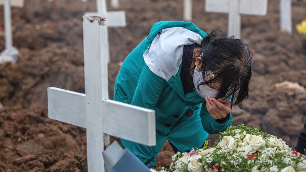 A woman crying during the burial of a daughter who died of COVID-19 at Rorotan Cemetery in Jakarta on Tuesday 13 July, 2021.