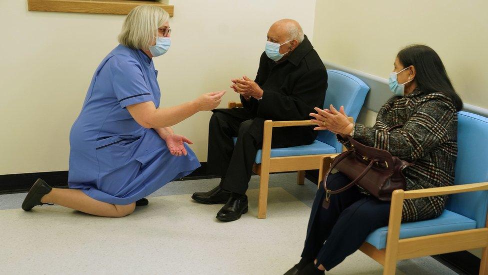 Retired nurse Suzanne Medows (left) speaks to race relations campaigner Dr Hari Shukla, 87, and his wife Ranju before he receives the first of two Pfizer/BioNTech Covid-19 vaccine jabs at the Royal Victoria Infirmary in Newcastle