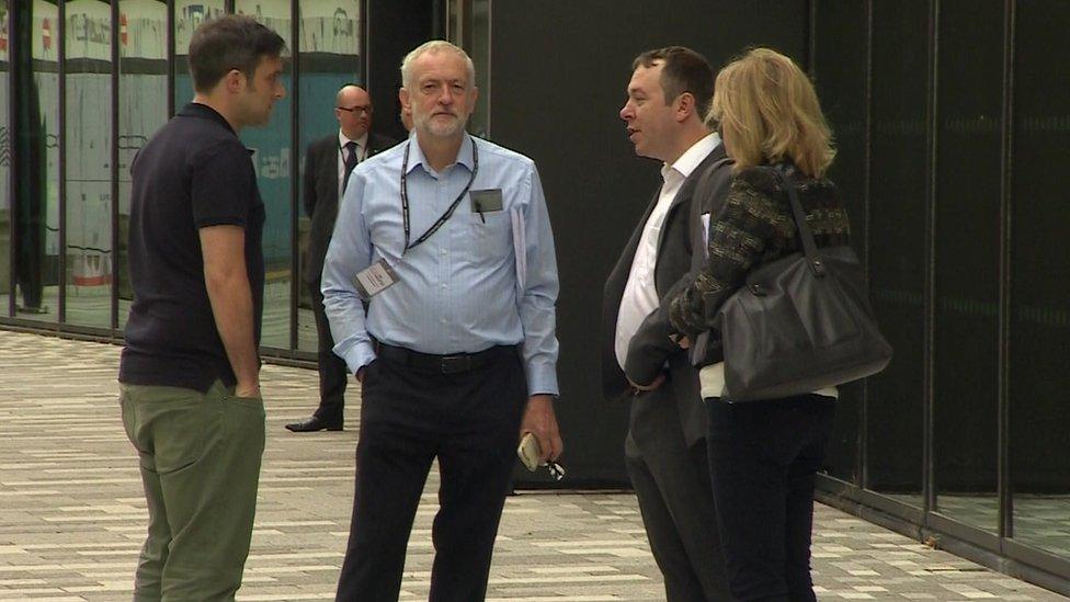 Jeremy Corbyn with Labour aides outside the conference venue