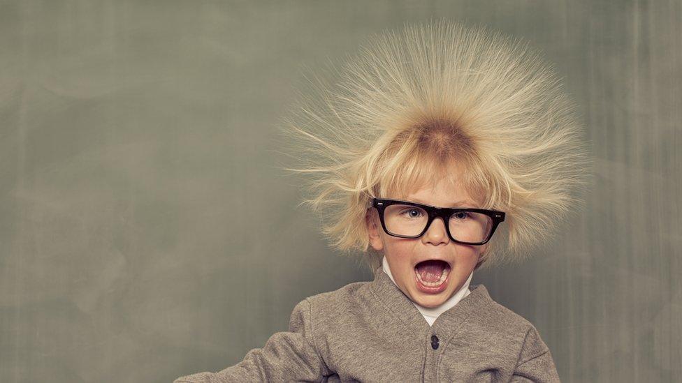 A boy with his hair standing on end (showing static electricity)