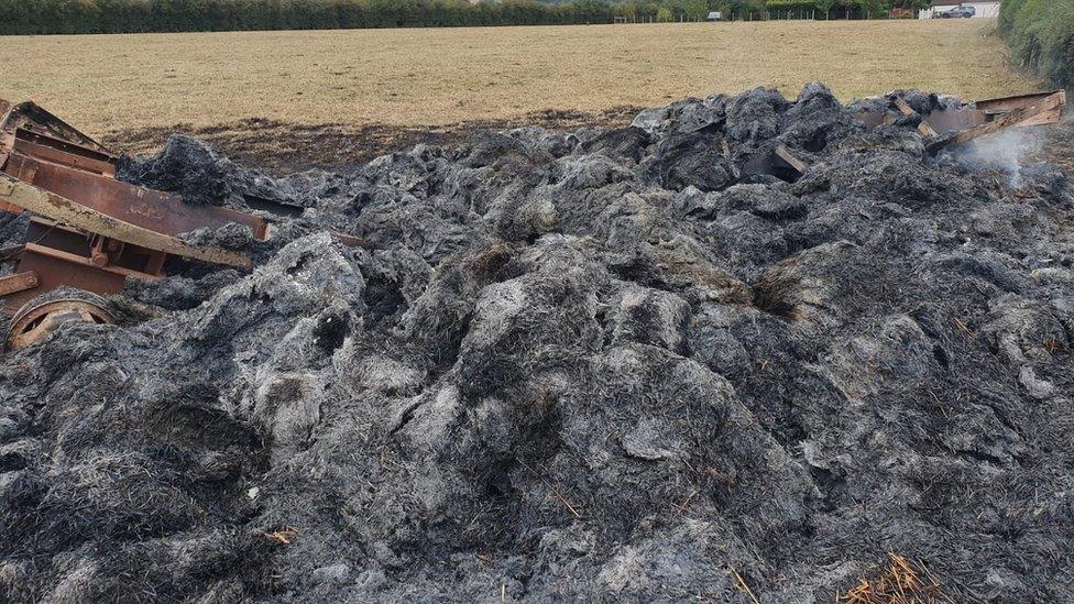 straw bale sculpture destroyed by fire