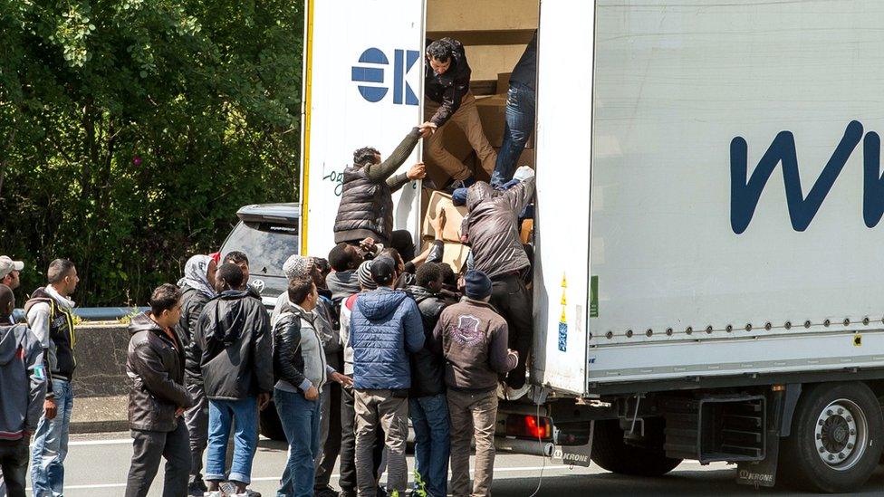 Migrants getting onto a truck heading for the Eurotunnel