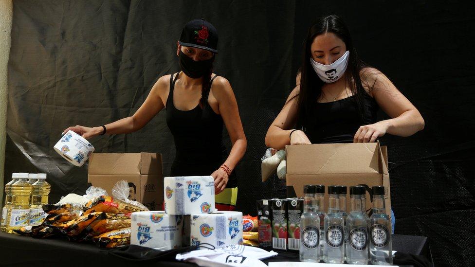 Employees of the clothing brand owned by El Chapo's daughter box up food supplies