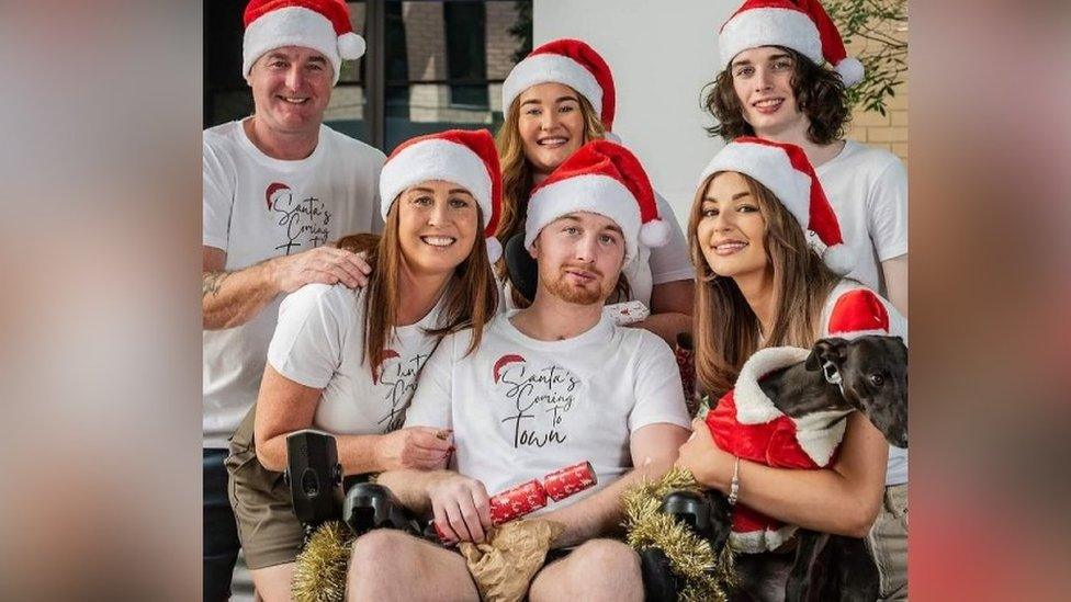 Danny and his family wearing Santa hats