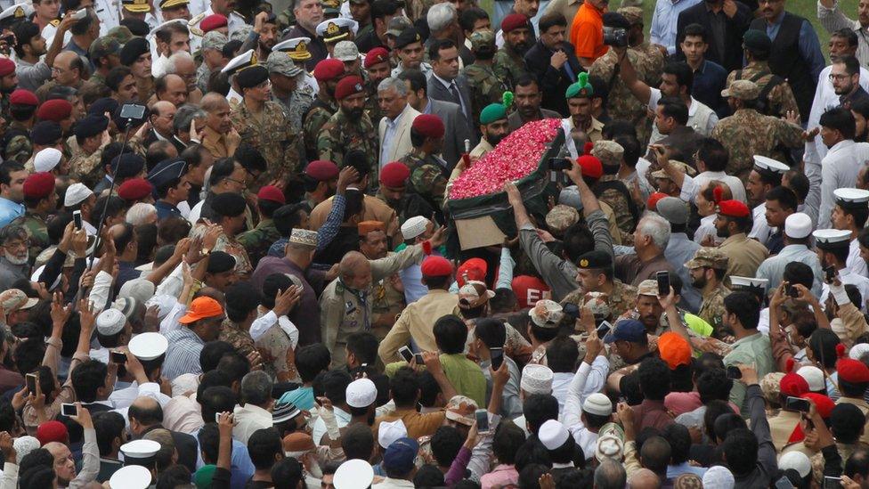 People try to touch the coffin of philanthropist Abdul Sattar Edhi during his funeral at the National Stadium in Karachi, Pakistan July 9, 2016