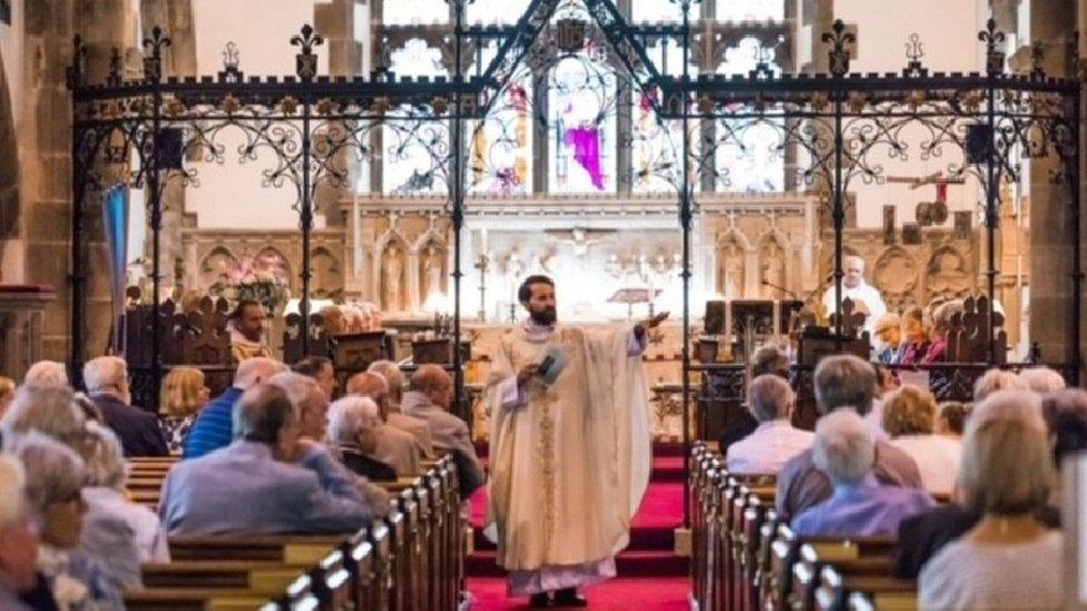 Father Lee Taylor address his congregation