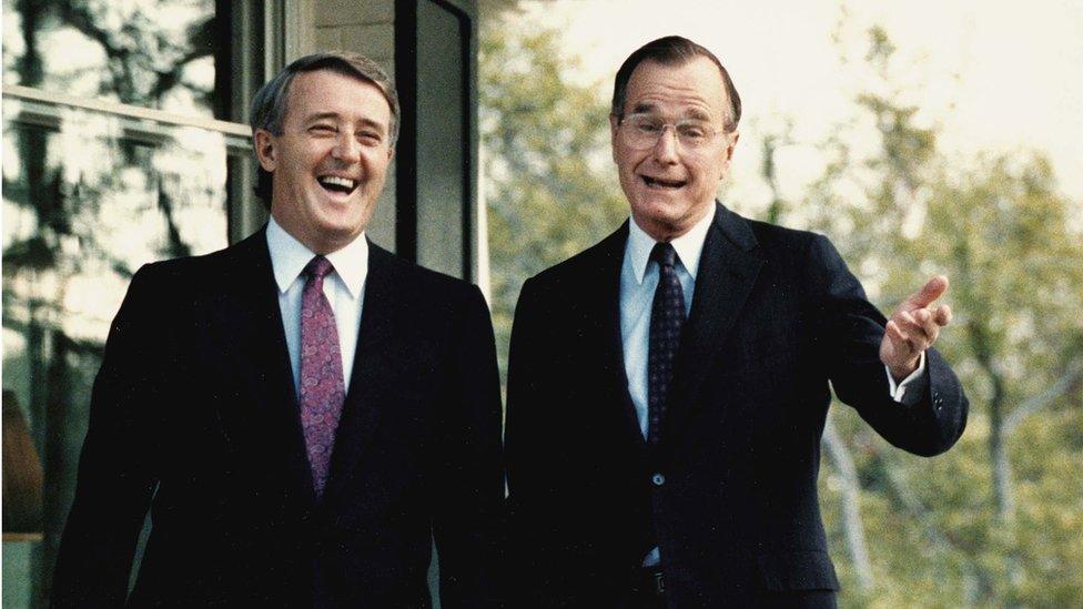 This file photo taken 28 April 1988, shows former US Vice President George Bush (R) as he shares a laugh with Canada's former Prime Minister Brian Mulroney, following a question from a reporter outside Bush's residence in Washington, DC. Mulroney was scheduled to have a second meeting with former US President Ronald Reagan later in the day.