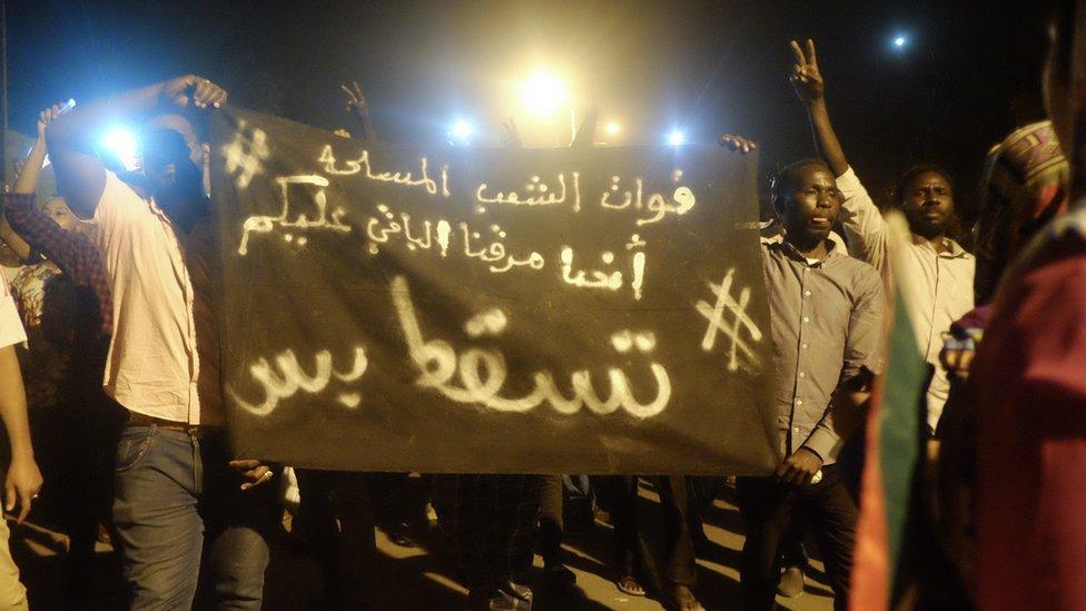 A banner reading "We came to protest on the street - and now it is your turn. #JustFall." at a sit-in at the military HQ in Khartoum, Sudan - Monday 8 April 2019