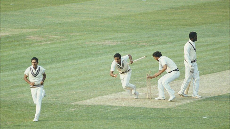 : Victorious India players Yaspal Sharma and Roger Binny grab souvenir stumps as Mohinder Amarnath (l) runs off the field as West Indies batsman Michael Holding looks on after the 1983 Prudential World Cup Final victory against West Indies at Lords on June 25, 1983 in London, England.