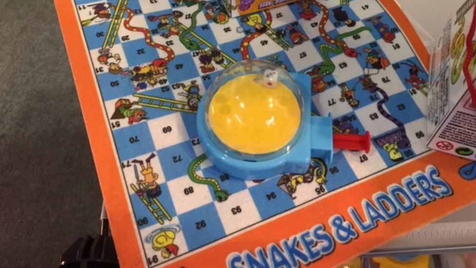 Snakes and ladders game with dice dome