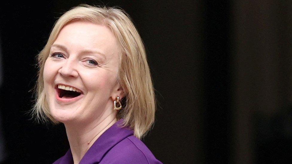 Liz Truss laughs as she arrives at Conservative Party Headquarters in central London