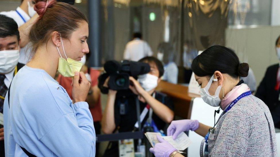 Krystina Timanovskaya has her documents checked at Narita International Airport