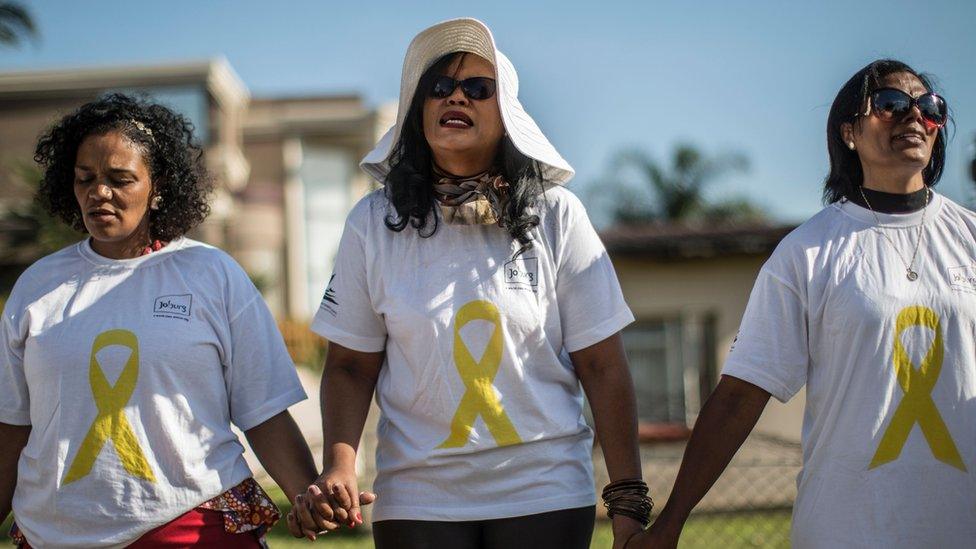 Community members gather for a prayer in Soweto, Johannesburg