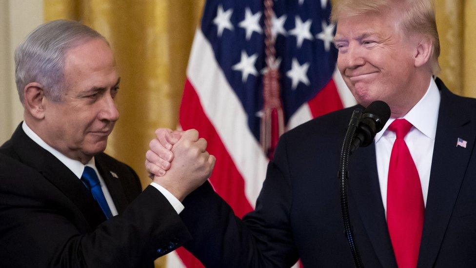 Israeli Prime Minister Benjamin Netanyahu shakes hands with Donald Trump after the unveiling of his vision for peace between Israel and the Palestinians at the White House (28 January 2020)