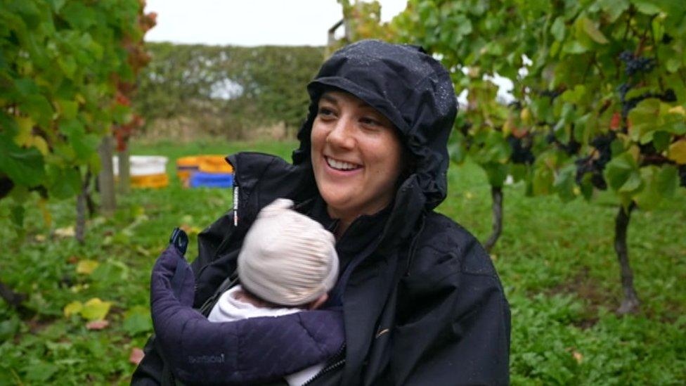 A woman and baby standing in front of vines in Shropshire