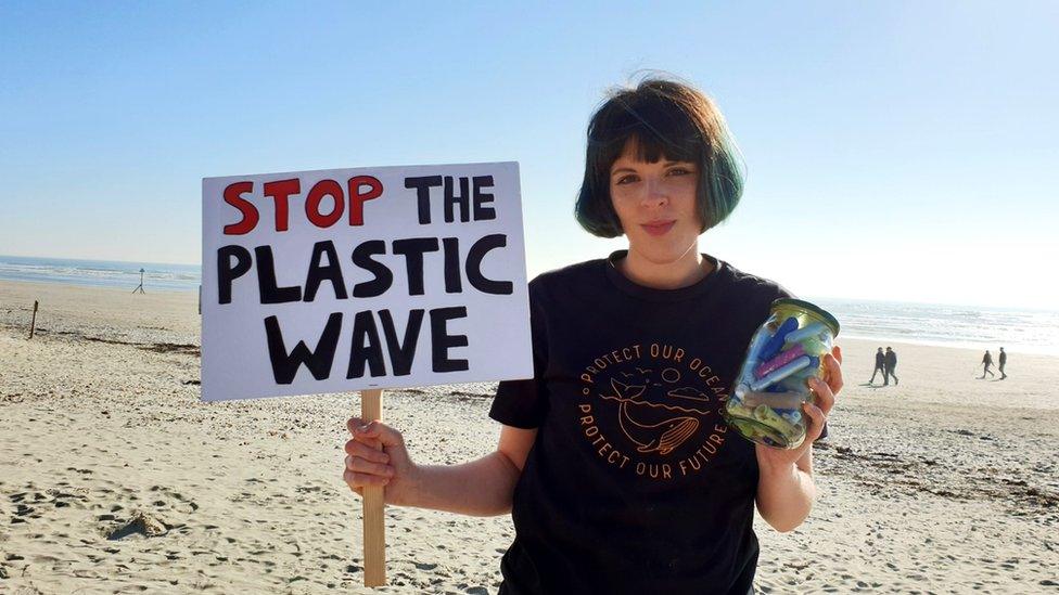 Ella Daish holding a 'stop the plastic wave' banner