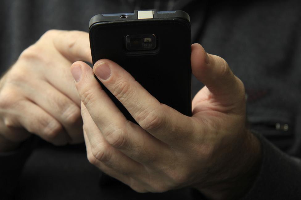 Detail of man using smartphone