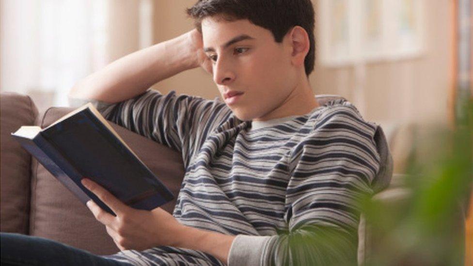 teenage boy reading