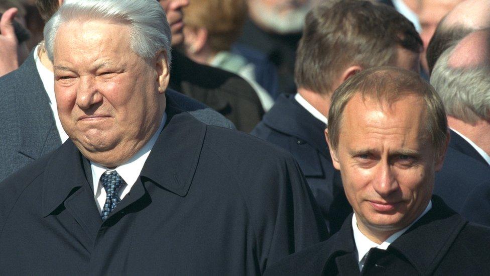 Boris Yeltsin (L) and Vladimir Putin at the Victory Day parade in Moscow's Red Square, May 2000