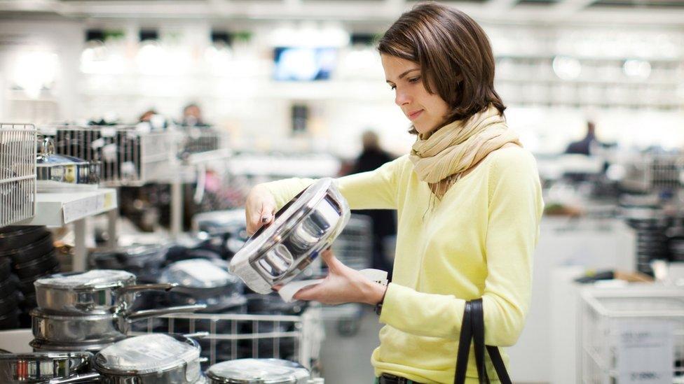 Woman shopping for kitchen pans