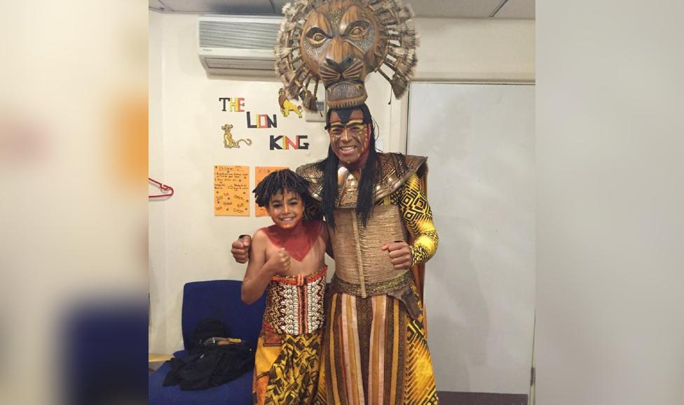 Amir behind stage of the lion king