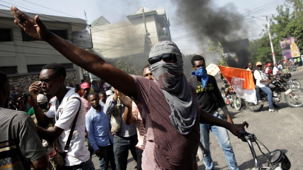 A demonstrator gestures during a protest to demand the resignation of Haitian president Jovenel Moïse, in Port-au-Prince, Haiti October 11, 2019