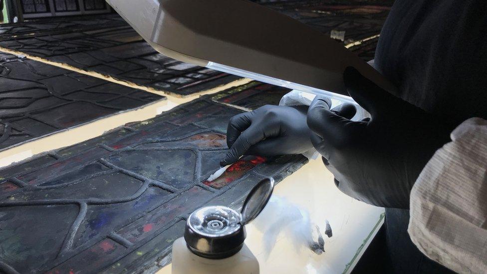 Flavie Vincent-Petit works on a stained glass window in Troyes