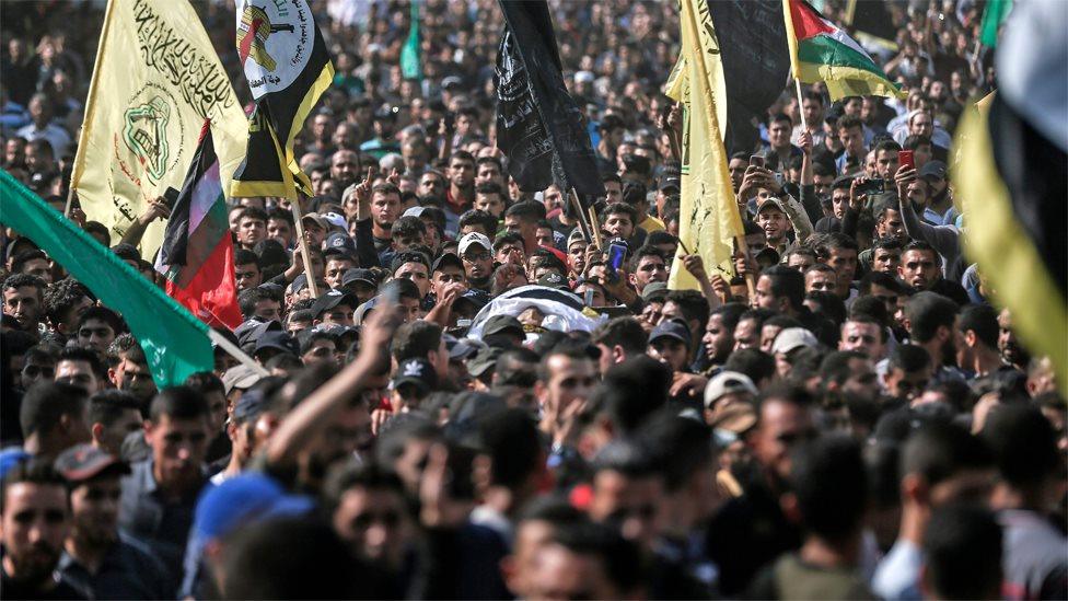 Mourners carry the body of Palestinian Islamic Jihad commander Baha Abu al-Ata at his funeral in Gaza City on 12 November 2019