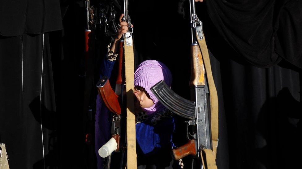 Girl in Sanaa with a rifle