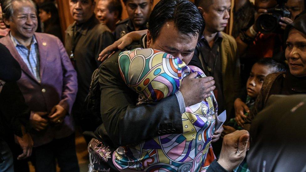 Mohd Nur Azrin Md Zin, 37, (2nd, L) the Malaysian nationals who returned from Pyongyang, hugs his mother Norhayati Hamid,(2nd, R