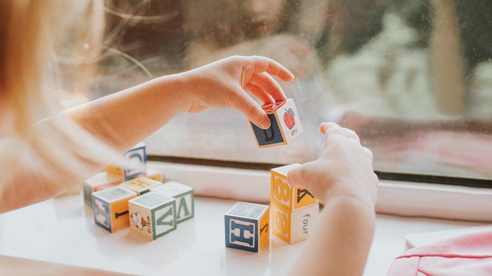 Girl playing with building blocks