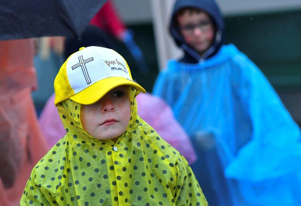 A child wearing a Pope Francis hat