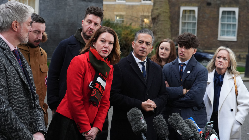 The families of the Nottingham attacks victims looking at a camera.