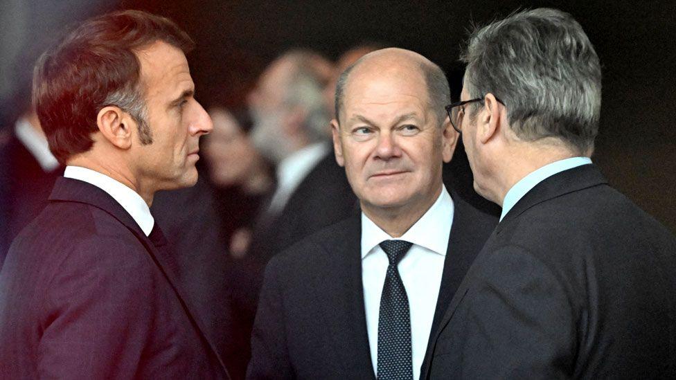 German Chancellor Olaf Scholz, French President Emmanuel Macron and British Prime Minister Keir Starmer talk together in Berlin in October 2024