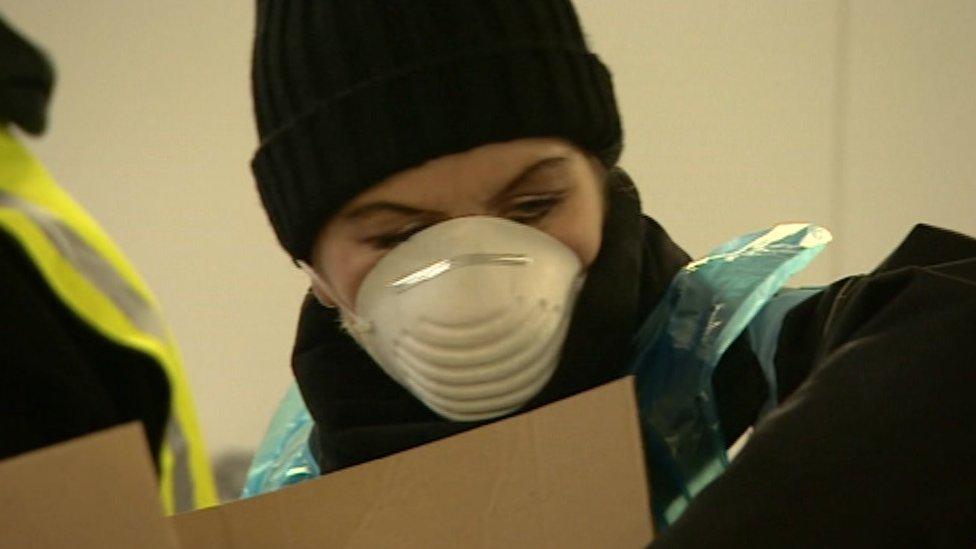 Worker packing food parcels in Birmingham