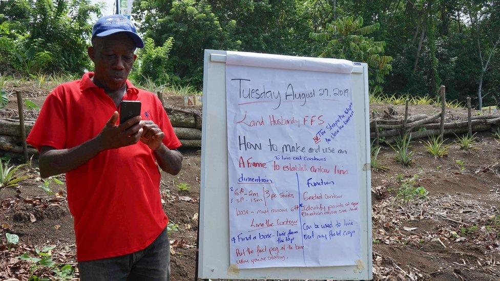 A man looks at his smartphone during training