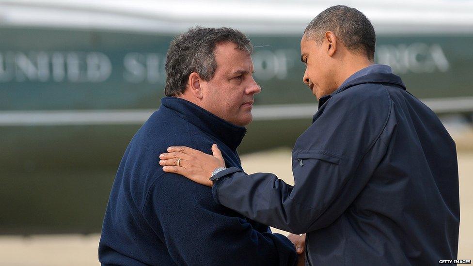 US President Barack Obama (R) is greeted by New Jersey Governor Chris Christie upon arriving in Atlantic City, New Jersey, on October 31, 2012